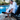 man wearing white robe sits in chair by pool and pus on black slippers